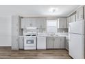A well-lit kitchen with grey cabinets, marble countertops, and modern appliances at 320 E Mckellips Rd # 195, Mesa, AZ 85201