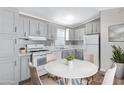 Charming kitchen featuring grey cabinets, marble countertops, and a cozy dining area at 320 E Mckellips Rd # 195, Mesa, AZ 85201