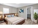 Cozy main bedroom featuring a comfortable bed, stylish decor, and ensuite bathroom access at 320 E Mckellips Rd # 195, Mesa, AZ 85201