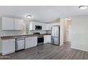 The modern kitchen features white cabinets, stainless steel appliances, and ample countertop space for cooking and entertaining at 320 E Mckellips Rd # 204, Mesa, AZ 85201