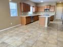 Bright kitchen features ample cabinetry, stainless steel appliances, a center island, and tile flooring at 5345 W Marcus Dr, Phoenix, AZ 85083