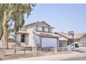 Traditional two-story home featuring a two-car garage, an enclosed front yard, and tidy landscaping at 1632 E Saint Charles Ave, Phoenix, AZ 85042