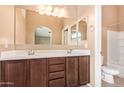 Bathroom featuring a dual-sink vanity, a large mirror, and a separate toilet area at 2725 E Mine Creek Rd # 1149, Phoenix, AZ 85024