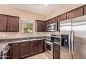 Kitchen featuring dark cabinetry, stainless steel appliances, and granite countertops at 2725 E Mine Creek Rd # 1149, Phoenix, AZ 85024