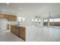 Open kitchen with large island featuring quartz countertops and stainless steel appliances at 2732 N 217Th Ave, Buckeye, AZ 85396