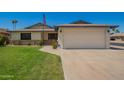 Charming single-Gathering home featuring a two-car garage, manicured lawn, and vibrant rose bushes at 3828 W Port Au Prince Ln, Phoenix, AZ 85053