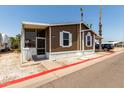 Inviting single-story home with neutral siding, white trim, covered patio, and well-kept landscaping at 625 W Mckellips Rd # 411, Mesa, AZ 85201