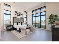 Spacious bedroom with large windows and gray headboard at 8366 E Old Paint Trl, Scottsdale, AZ 85266