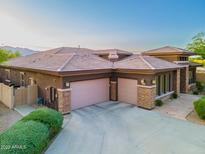 Rear exterior featuring three garage doors and desert landscaping at 12797 S 179Th Dr, Goodyear, AZ 85338