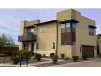 Tan two-story house with a brown garage door and small landscaping at 31510 N 24Th Dr, Phoenix, AZ 85085