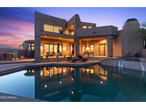 Luxury home with a stunning pool and desert landscape at sunset at 14021 E Milton Ct, Scottsdale, AZ 85262