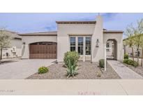 Charming single-story home with a desert-landscaped front yard and a stylish brown garage door at 578 E Las Puertas Ln, Queen Creek, AZ 85140