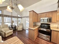 Charming kitchen featuring stainless steel appliances, wood cabinets and eat in breakfast nook with lots of natural light at 1044 S Quartz Dr, Apache Junction, AZ 85119