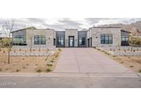 A modern desert home with a long driveway and stone accents at 12297 E Troon Vista Dr # 255, Scottsdale, AZ 85255