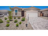 Charming single-Gathering home featuring a well-maintained front yard with desert landscaping and a brick paved driveway at 18450 E Camila Dr, Gold Canyon, AZ 85118