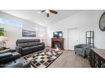 Relaxing living room with gray couches, fireplace, and wood-look floors at 724 Emerald Dr, Apache Junction, AZ 85119