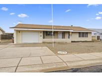 Brick ranch home with a white garage door and landscaped yard at 6315 E Billings St, Mesa, AZ 85205