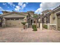 Two-car garage with stucco exterior and landscaped front yard at 6202 E Mckellips Rd # 40, Mesa, AZ 85215