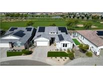 Beautiful single Gathering home featuring solar panels, landscaped yard, and a view of the community golf course at 17316 W Wildwood St, Surprise, AZ 85388