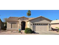 Charming single-story home with desert landscaping, attached garage, and tiled roof, under a clear blue sky at 2101 S Meridian Rd # 34, Apache Junction, AZ 85120