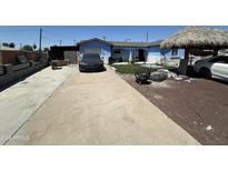 Charming blue single-story home featuring a long driveway and potential backyard oasis at 5007 W Weldon Ave, Phoenix, AZ 85031