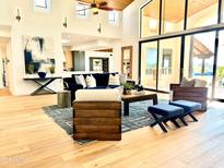 Bright living room featuring hardwood floors, high ceilings, large windows, and stylish furniture at 24724 N 119Th Pl, Scottsdale, AZ 85255