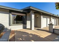 House exterior featuring a light brick facade, and a two-car garage at 7950 E Keats Ave # 133, Mesa, AZ 85209