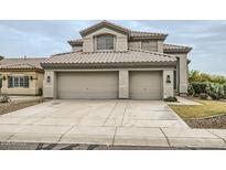 Charming two-story home showcasing a desert landscape and a three-car garage at 4803 E Barwick Dr, Cave Creek, AZ 85331
