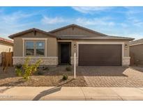 Single-story home with attractive stone and neutral siding at 40461 W Wade Dr, Maricopa, AZ 85138