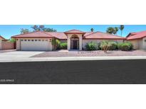 Charming home featuring a red tile roof, desert landscaping, and an arched entryway at 2119 N Lake Shore Dr, Casa Grande, AZ 85122