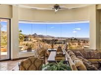 Elegant living room with oversized windows showcasing mountain views and desert landscape at 10537 N Crestview Dr, Fountain Hills, AZ 85268