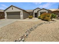 Charming single-story home featuring low-maintenance desert landscaping and a neutral color palette at 16186 W Silver Falls Dr, Surprise, AZ 85374