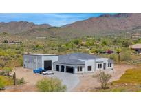 Stunning aerial view of a modern home with a detached garage, showcasing a desirable location at 6501 E Willow Springs N Ln, Cave Creek, AZ 85331