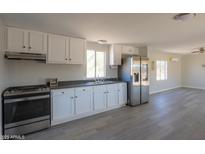 Modern kitchen featuring stainless steel appliances and ample cabinetry at 192 S Ralston Rd, Maricopa, AZ 85139