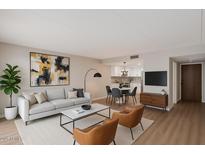Bright living room featuring modern furnishings, wood floors, and an open floor plan at 7930 E Camelback Rd # 506, Scottsdale, AZ 85251