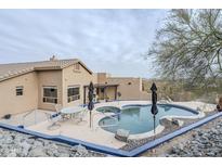 Image of desert home's backyard pool with nearby outdoor seating area at 18315 W Santa Alberta Ln, Goodyear, AZ 85338