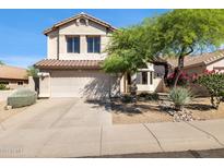 Charming two-story home with a well-maintained front yard and attached two-car garage at 10402 E Saltillo Dr, Scottsdale, AZ 85255
