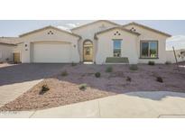 Single-story home with a two-car garage and landscaped front yard at 20277 W Mulberry Dr, Buckeye, AZ 85396