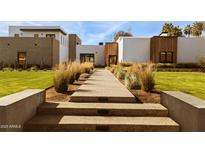 Beautiful home exterior featuring a textured facade, desert landscaping, and a inviting walkway at 4350 N Jokake Dr, Scottsdale, AZ 85251