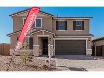 Two-story house with a brown garage door and stone accents at 11530 S 50Th Ln, Laveen, AZ 85339