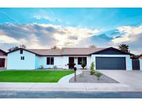 Updated single-story home with modern exterior and landscaped lawn at 17207 N 36Th St, Phoenix, AZ 85032