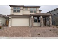 Two-story house with stone accents and a paved driveway at 17632 W Oregon Ave, Litchfield Park, AZ 85340