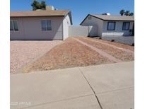 Well-maintained single-story home featuring low maintenance desert landscaping and a concrete driveway at 3222 W Wagoner Rd, Phoenix, AZ 85053
