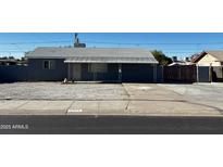 Gray house with carport and gated driveway at 12438 N 111Th Ave, Youngtown, AZ 85363