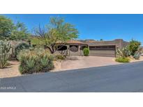 Spanish-style home with a large driveway and desert landscaping at 1710 E Staghorn Ln, Carefree, AZ 85377