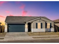 New single-story home with dark gray garage door and landscaping at 25218 N 160Th Dr, Surprise, AZ 85387