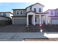 Charming two-story home with a well-manicured lawn and inviting front porch at 26405 N 19Th Dr, Phoenix, AZ 85085