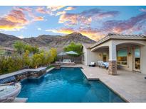 Gorgeous backyard featuring a swimming pool, outdoor seating, and a mountain view at 16002 S 27Th Dr, Phoenix, AZ 85045