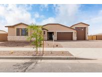 Charming single-story home featuring desert landscaping, three car garage and a neutral color palette at 19655 E Estrella Rd, Queen Creek, AZ 85142