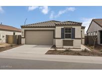 Charming single-story home with a tile roof, a two-car garage, and low-maintenance landscaping at 5729 S 243Rd Dr, Buckeye, AZ 85326